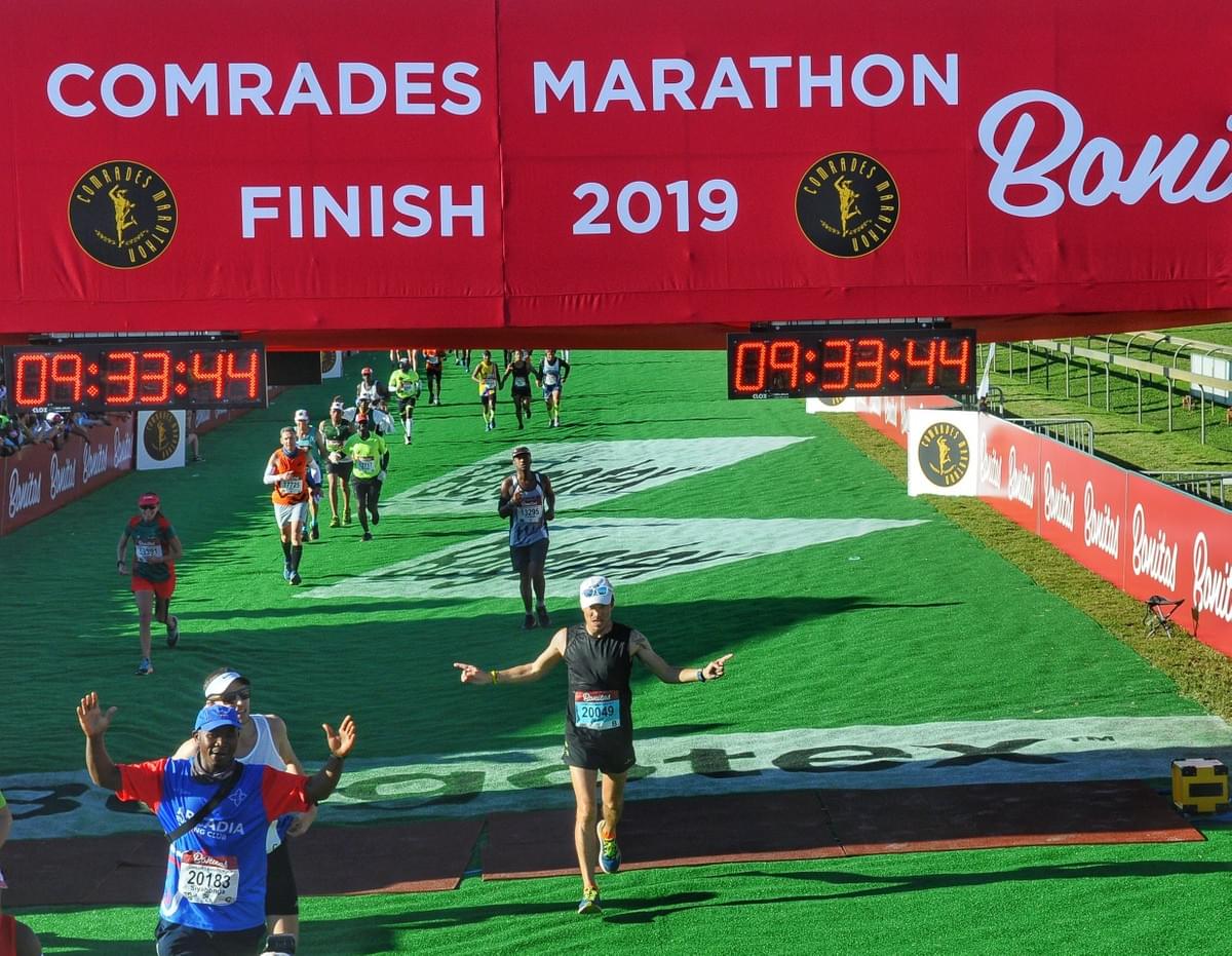 Runner celebrates crossing the finish line of the 2019 Comrades Ultra Marathon at Scottsville Racecourse in Pietermaritzburg Runner celebrates crossing the finish line of the 2019 Comrades Ultra Marathon at Scottsville Racecourse in Pietermaritzburg