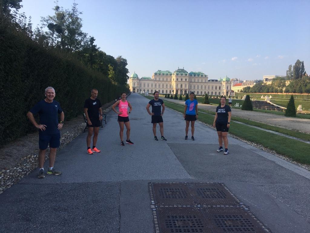 Running group pauses for photo at Belvedere Castle during a run in Vienna, Austria Running group pauses for photo at Belvedere Castle during a run in Vienna, Austria