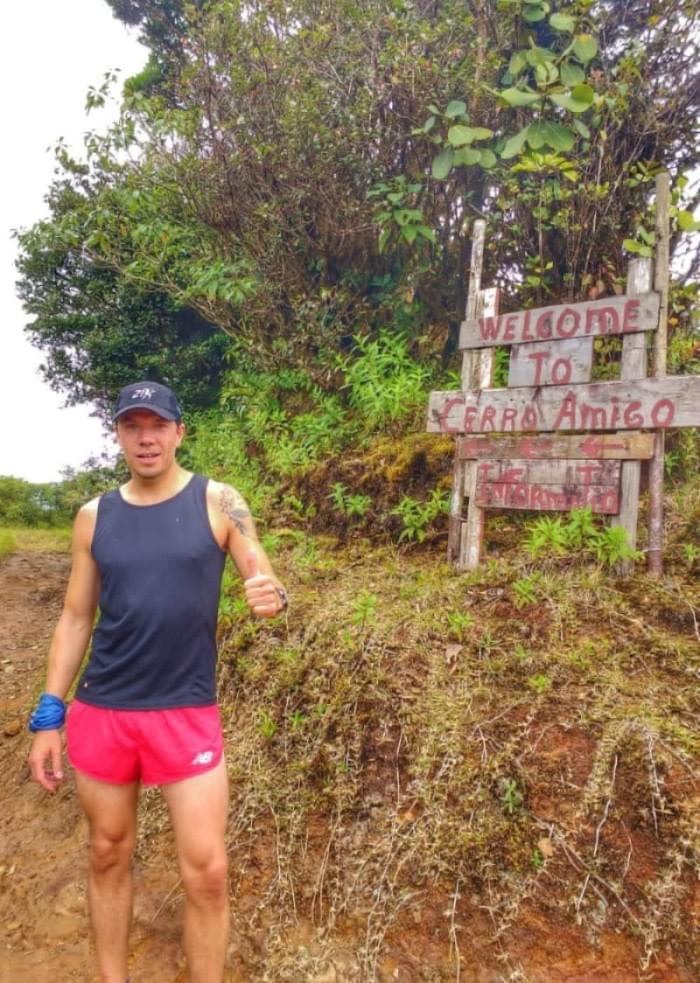 Standing by the sign at the top of Cerro Amigo, Monteverde Standing by the sign at the top of Cerro Amigo, Monteverde