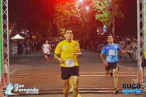 runner crossing finish line at Corrida Internacional de San Fernando uruguay runner crossing finish line at Corrida Internacional de San Fernando uruguay