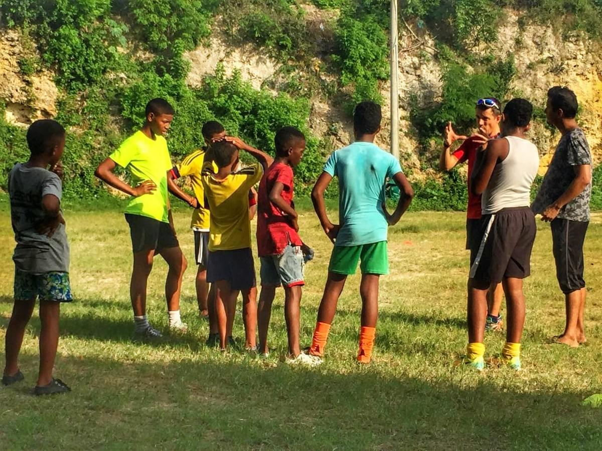 Local children listen in during a talk before a running session in Cartagena, Colombia Local children listen in during a talk before a running session in Cartagena, Colombia