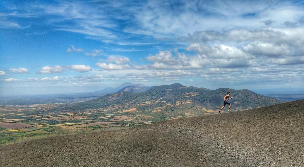 Running the incline of Cerro Negro volcano, in the background, hills as far as the eye can see Running the incline of Cerro Negro volcano, in the background, hills as far as the eye can see