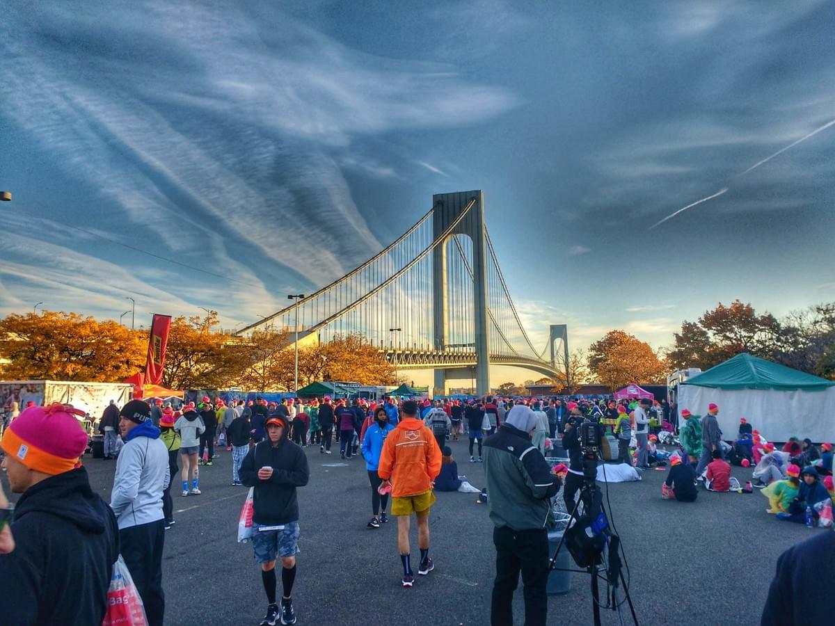 Runners walk the New York City Marathon race village at Ford Wadsworth on Staten Island, Verrazano-Narrows Bridge looms large in the background Runners walk the New York City Marathon race village at Ford Wadsworth on Staten Island, Verrazano-Narrows Bridge looms large in the background