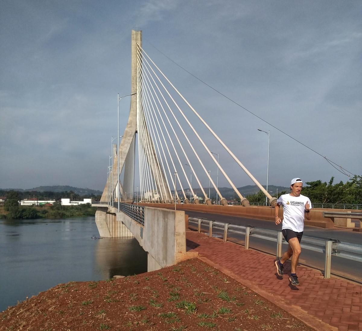 A runner crosses the Source of the Nile bridge in Jinja, Uganda A runner crosses the Source of the Nile bridge in Jinja, Uganda
