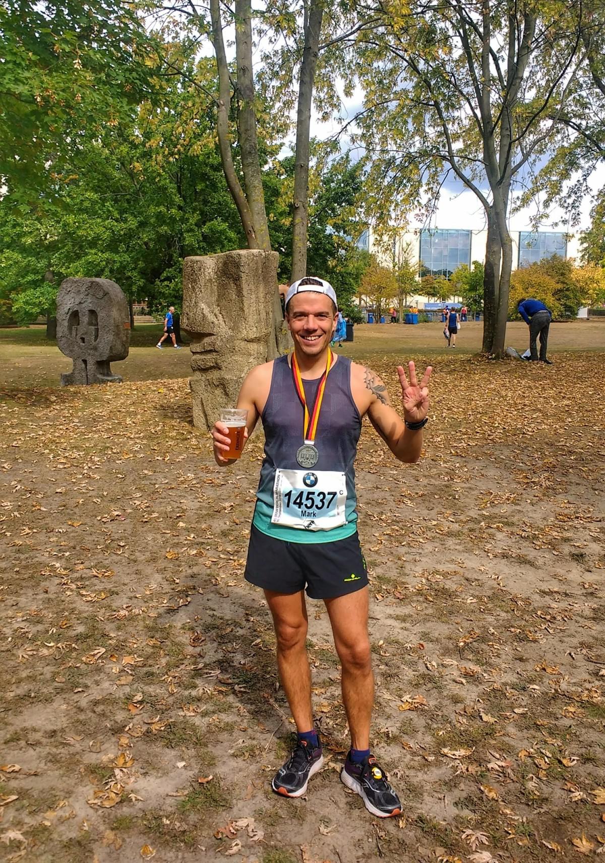 Berlin Marathon post-race medal and beer celebration in the Tiergarten Berlin Marathon post-race medal and beer celebration in the Tiergarten