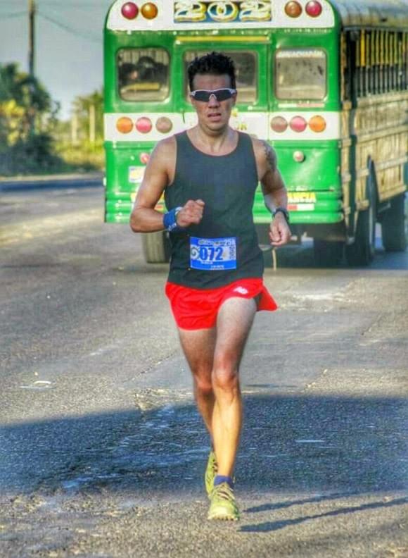 Running alongside a chicken bus during a race in El Salvador Running alongside a chicken bus during a race in El Salvador