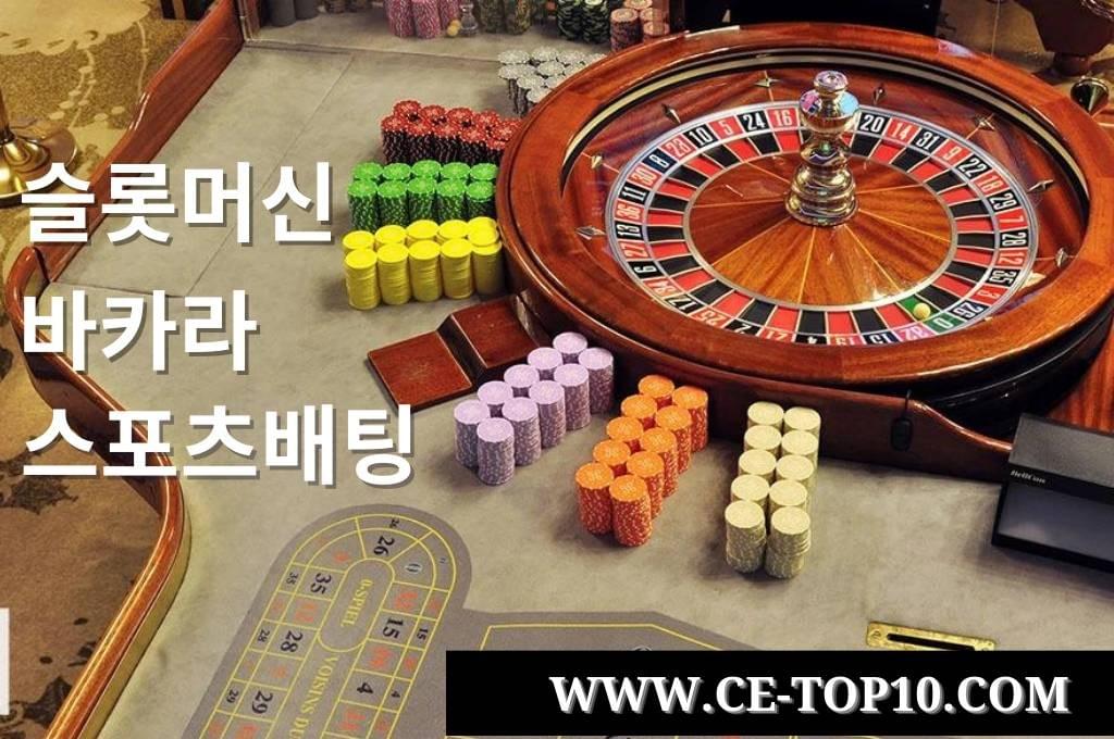 Gray roulette table with wood roulette wheel and chips Gray roulette table with wood roulette wheel and chips