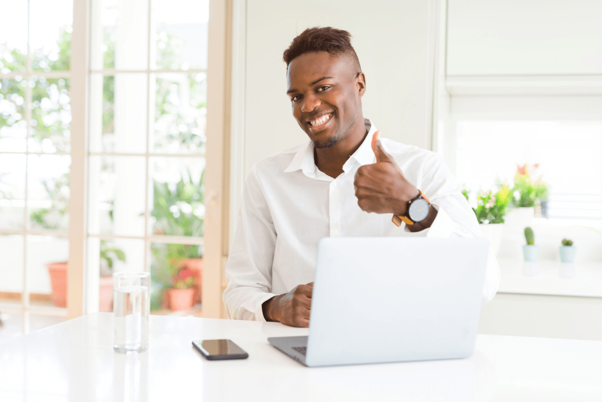 Young Man at Table With Thumbs Up Young Man at Table With Thumbs Up