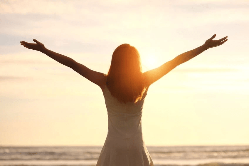 Image of Woman at Beach with Outstretched Arms Image of Woman at Beach with Outstretched Arms