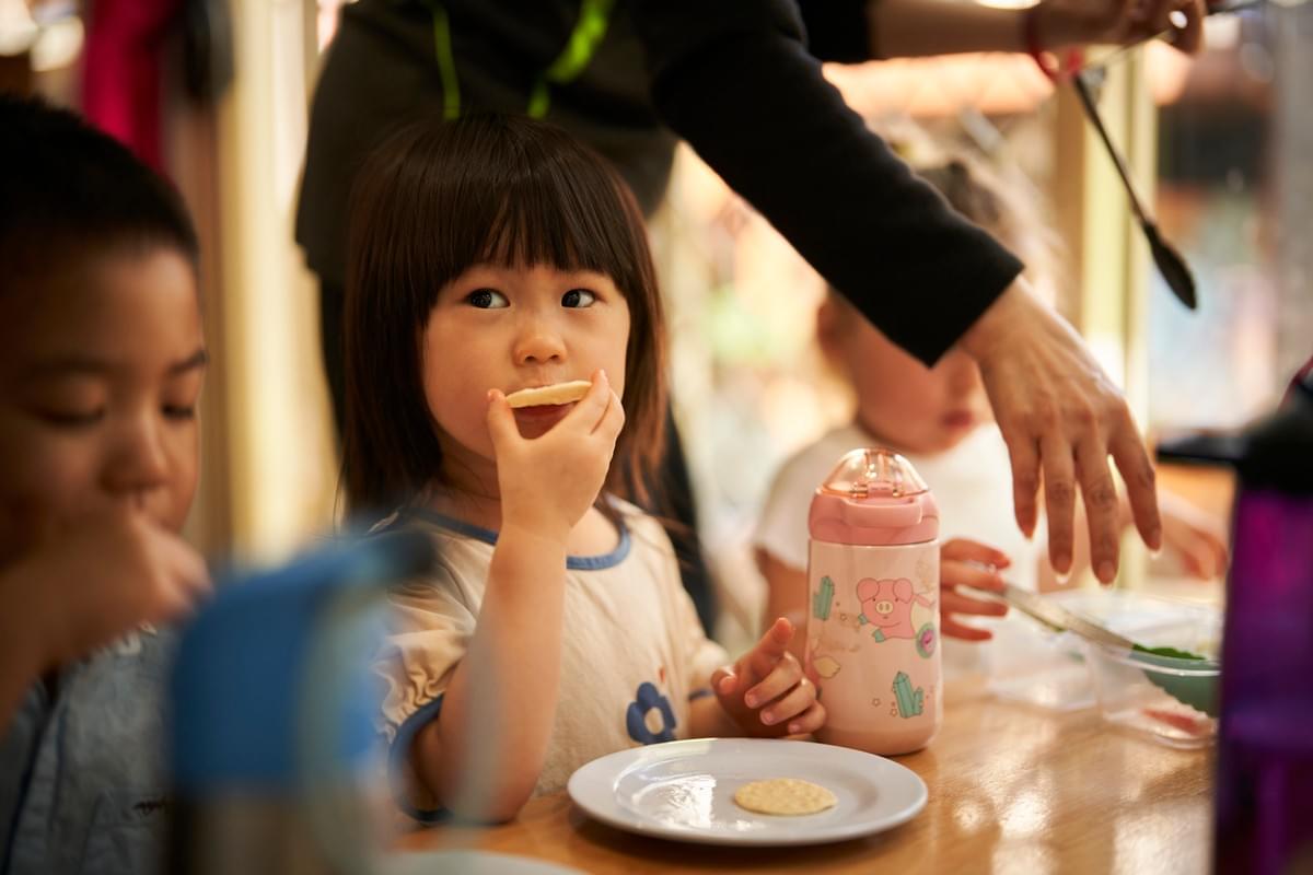 Child enjoying morning tea Child enjoying morning tea
