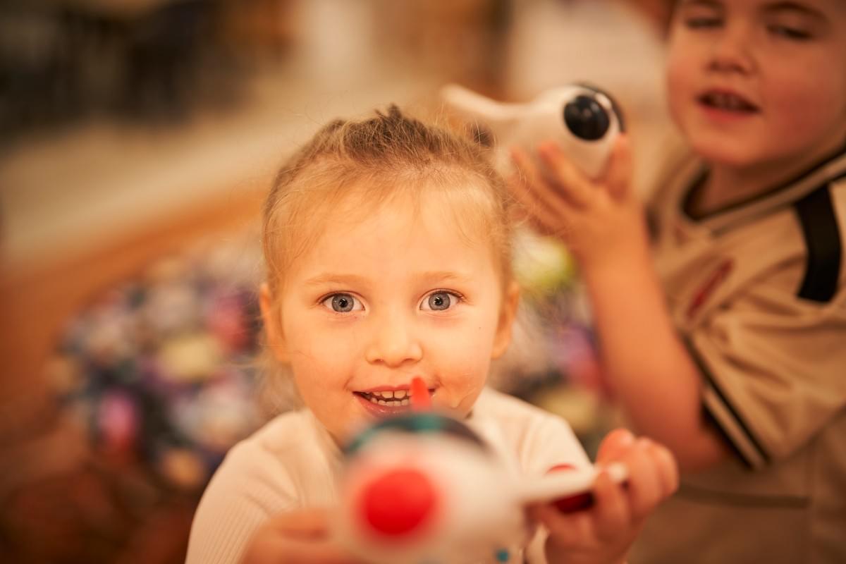 Smiling child playing with a toy Smiling child playing with a toy