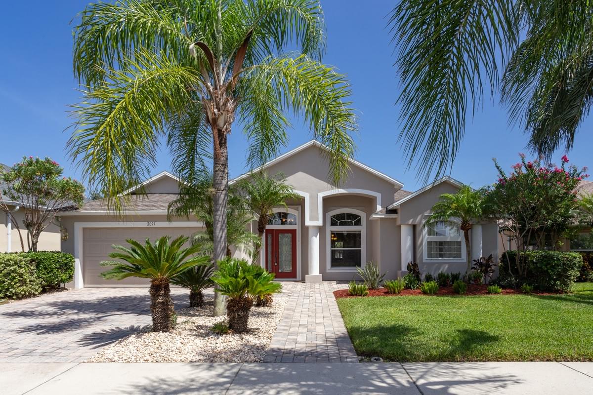 Tan single story home with white trim. Tan single story home with white trim.
