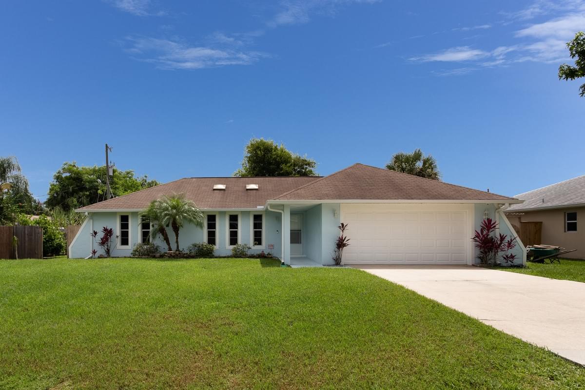 Cute blue home with blue skys behind it. Cute blue home with blue skys behind it.