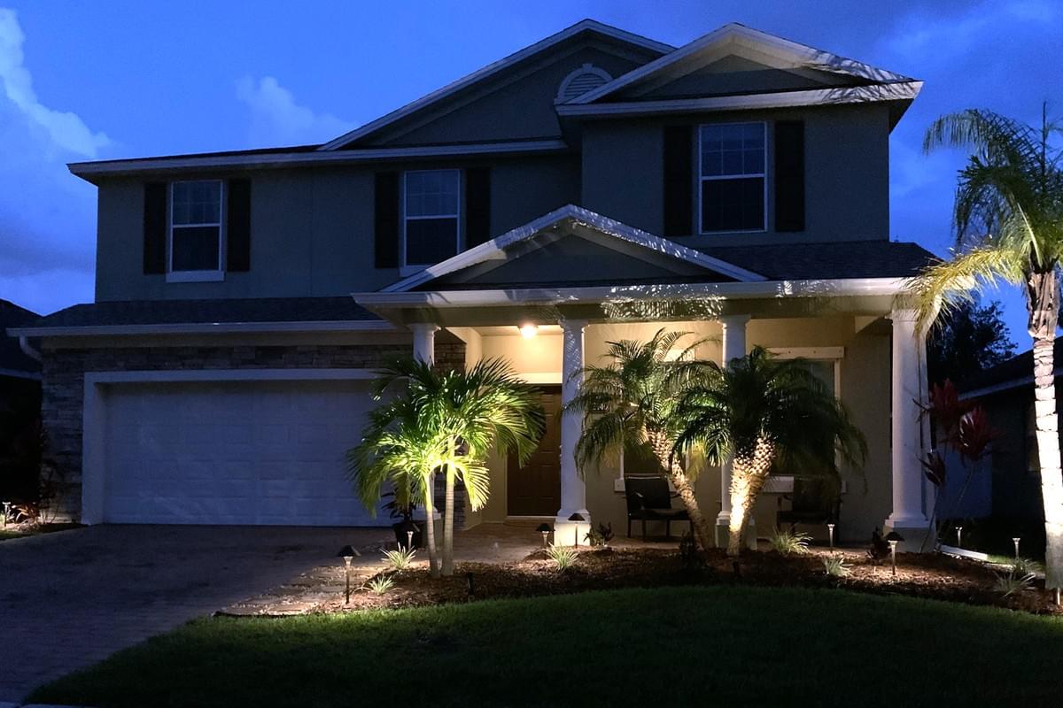 Photo of two story home at twilight with accent lighting on the home. Photo of two story home at twilight with accent lighting on the home.