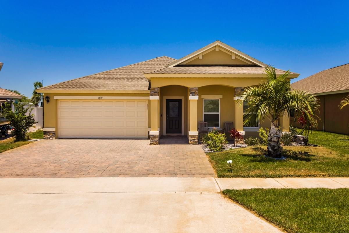 Yellow colored single story home with palm tree in front Yellow colored single story home with palm tree in front