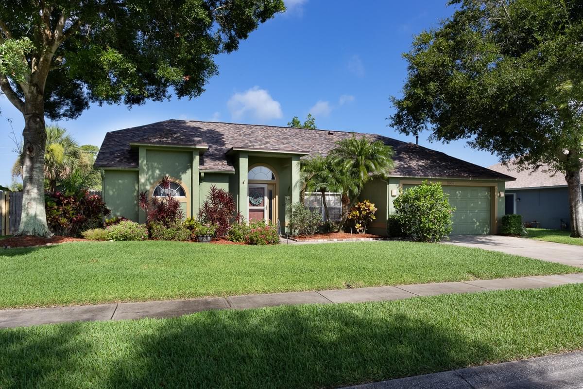 Lovely home painted green with large mature oak trees Lovely home painted green with large mature oak trees