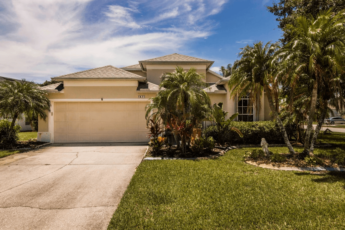 tan single story home with palms in front tan single story home with palms in front