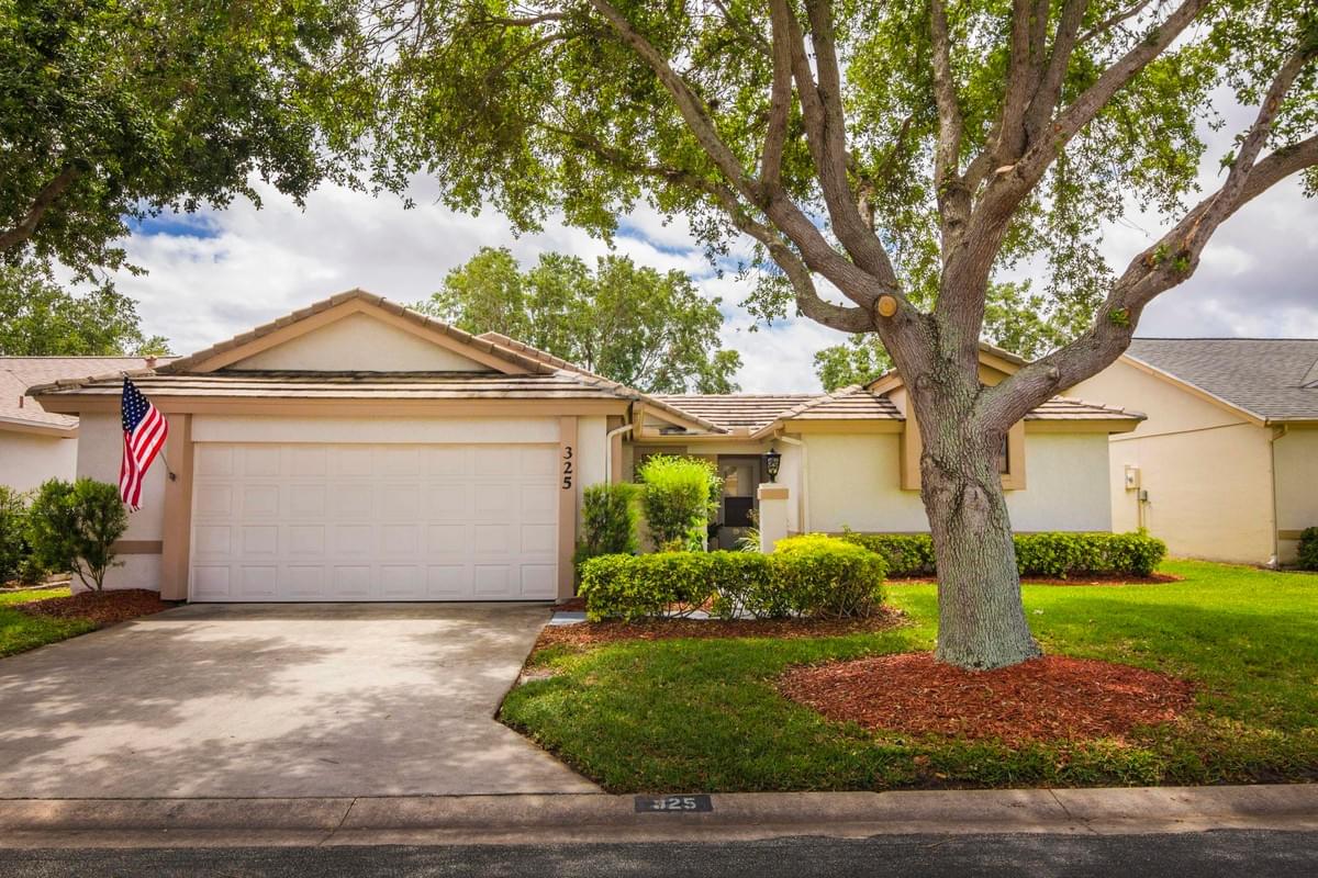 tan single story home with large oak tree in front tan single story home with large oak tree in front
