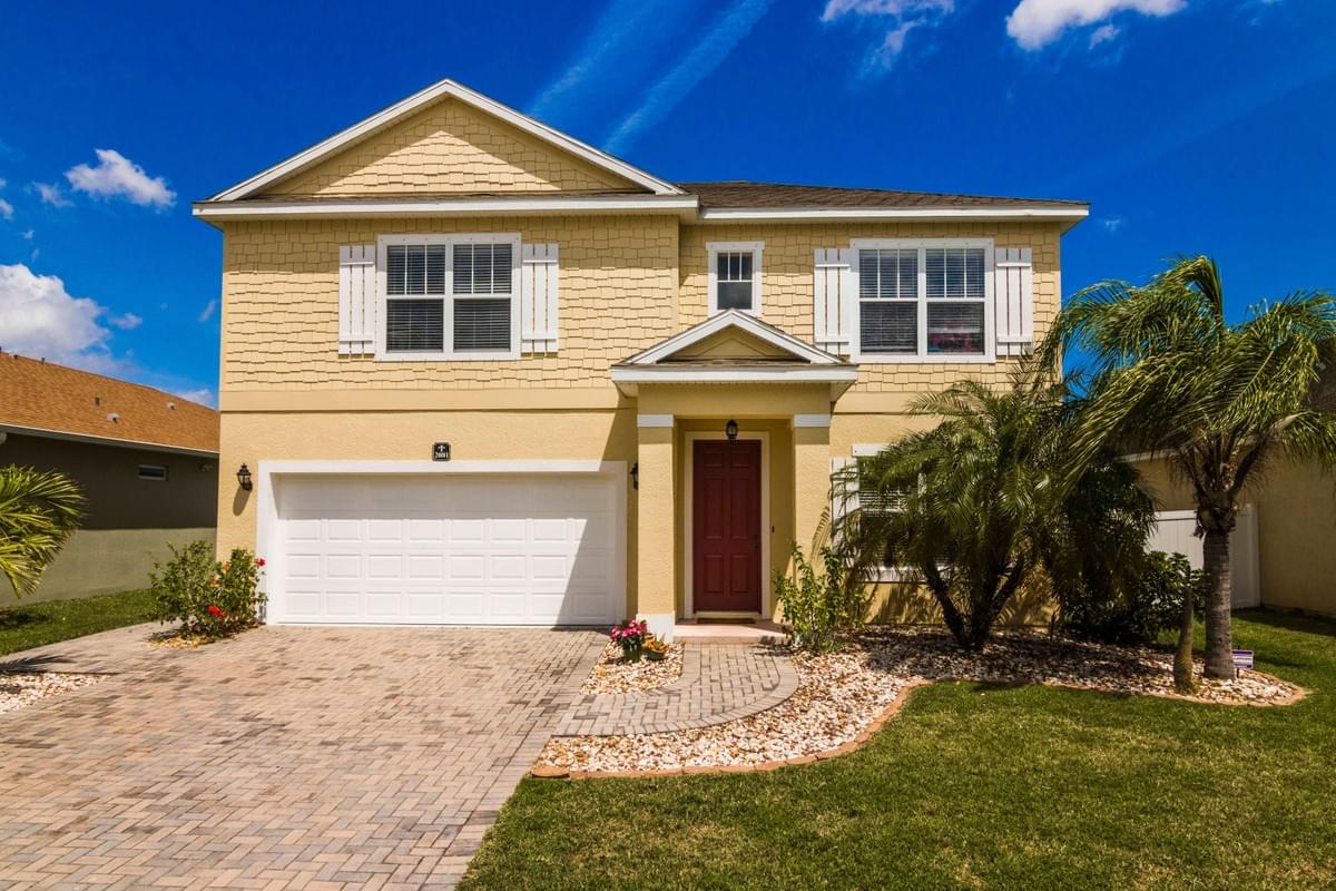 Yellow two story home with red accent door Yellow two story home with red accent door