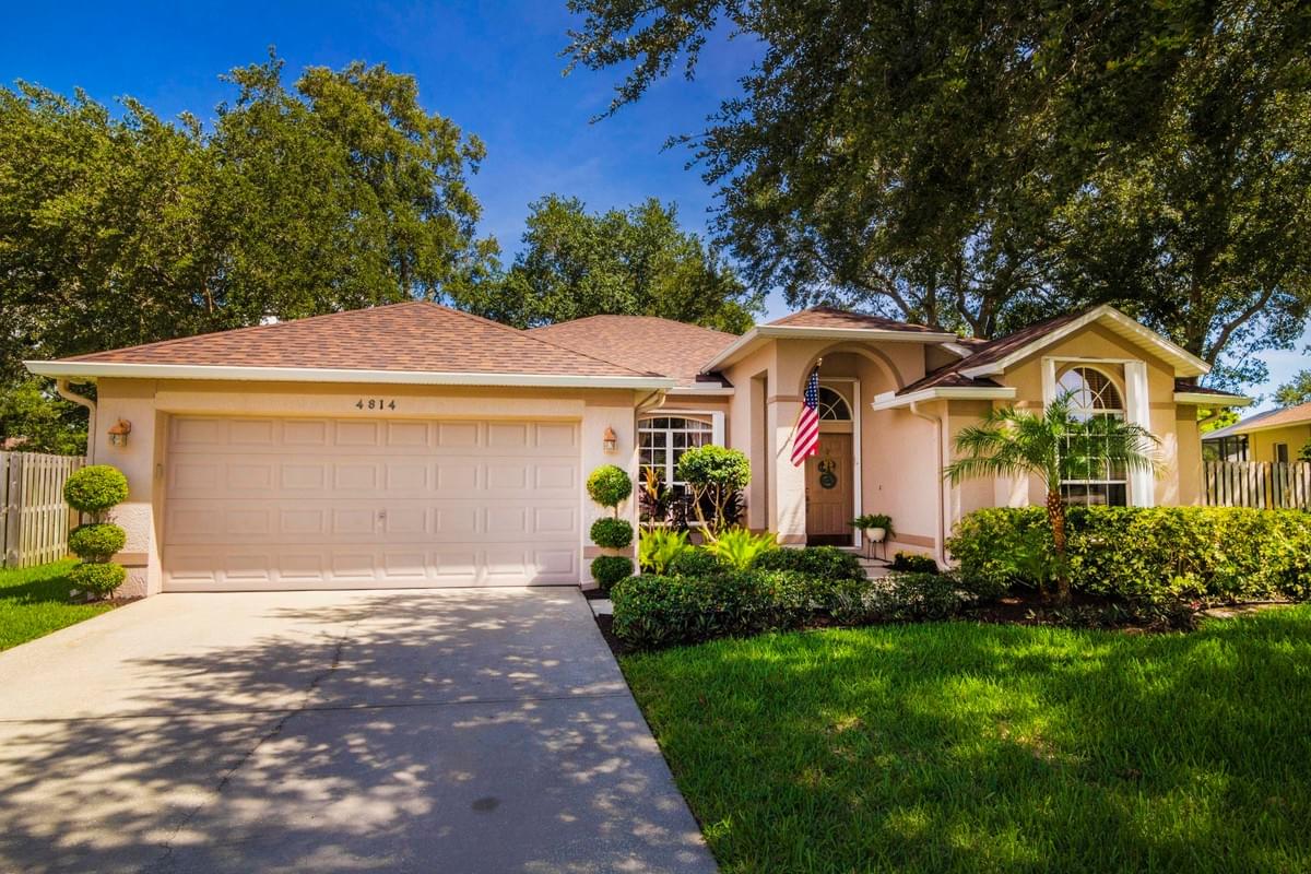 tan single story home with large oak tree in front tan single story home with large oak tree in front