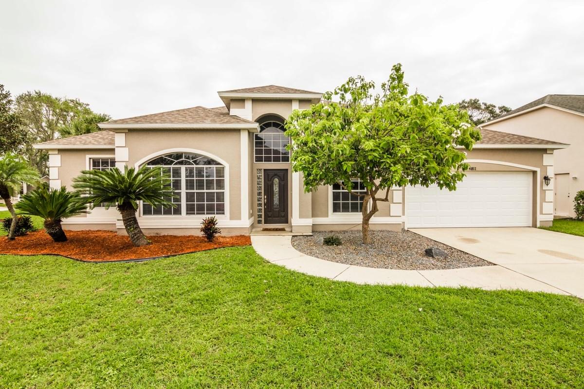 tan single story home with small tree in front tan single story home with small tree in front