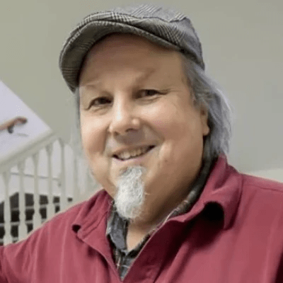 Smiling man with hat and goatee. Smiling man with hat and goatee.