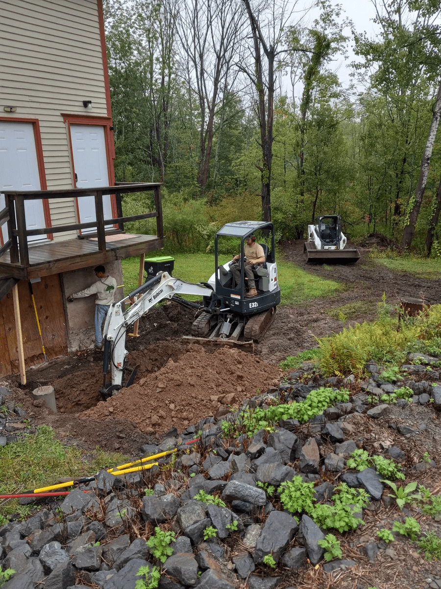 Using a mini Excavator for Drain installation in NE PA near Lake Ariel. Using a mini Excavator for Drain installation in NE PA near Lake Ariel.