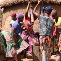 Women pounding shea nuts