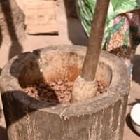 Pounding shea nuts up close