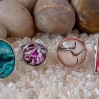 Two different size round rings and larger oval style, all on adjustable bands.