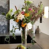 Tall vase flower arrangement