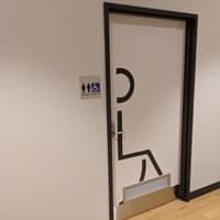 A white wall and black door frame