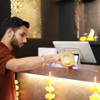 Copper Chimney staff lighting a diya for Diwali celebrations