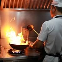 Chef cooking authentic Indian dishes at Copper Chimney.