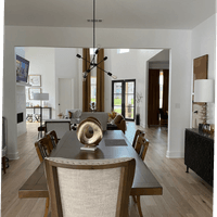 Mid-Century modern dining room featuring neutral color palette and cozy furnishings lighting.