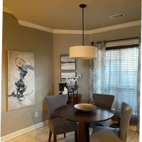 Transitional dining room featuring neutral color palette and cozy furnishings and lighting.