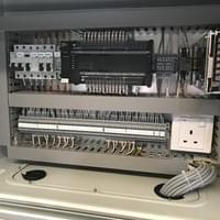 Omron PLC control panel with neat color-coded wiring