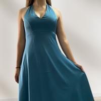 Vacations in silk shine through for this young woman who wears a halter-neck dress that's as light as a summer's day.