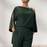 Sophisticated and versatile in forest green silk pants and off-shoulder top — expressing personal style and grace.