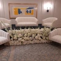Bedeken design with white modern couches and floral for Jewish wedding cocktail hour