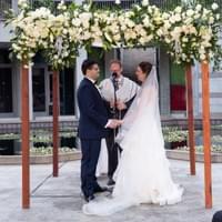 Chuppah design at Skirball Cultural Center during wedding ceremony with white floral and greenery