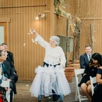 Grandma flower girl with dressed up walker throwing petals