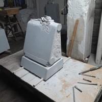 Hand-carved rose in raised relief in granite