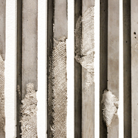 59 Pieces. A handwoven fragment was slowly cut apart to create this work. Its disappearance is documented in the work. Concrete, handwoven cotton, dimensions vary.