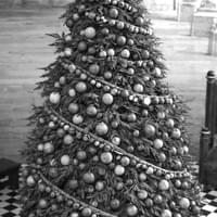 Wooden Bauble decorated tree with paper wrapped wire balled garland
