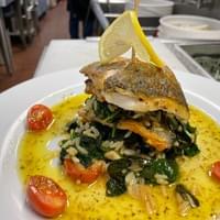 Bronzino file with spinach rice and lemon sauce
