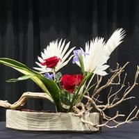 Akira Sataki container, bleached manzanita branch, bleached palm fronds, variegated aspidistra, red roses, irises