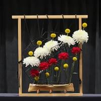Ceramic container, metal grid, wood frame, black silk cord, plastic mesh chrysanthemums, carnations, Billy balls