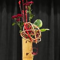 Bamboo container, rattan kaun wrapped in red cord, spray roses, hosta, mizuhiki