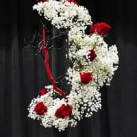 Ichiyo School iron container, manzanita branch painted black wrapped in red cord, baby’s breath, roses